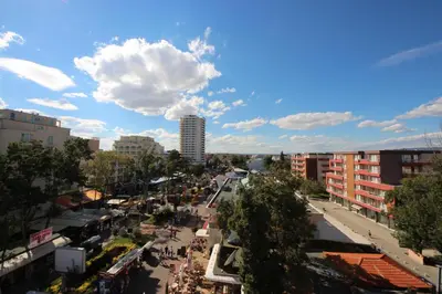 a city street with buildings and a cloudy sky at Menada Midia Apartments in Sunny Beach