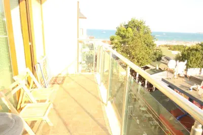 a balcony with chairs and a view of the ocean at Menada Midia Apartments in Sunny Beach