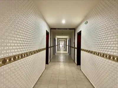 a hallway with white walls and a long corridor at Menada Miramar Palace Apartments in Sunny Beach