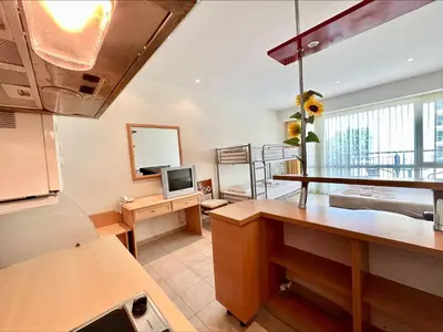 a kitchen with a counter top and a tv in a room at Menada Miramar Palace Apartments in Sunny Beach