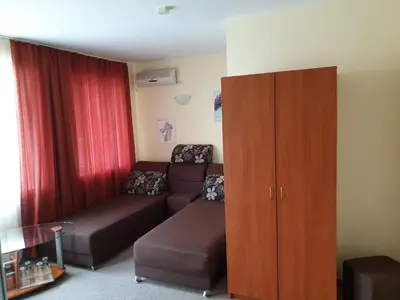 a living room with a couch and a cabinet at Family Hotel Diana in Pomorie
