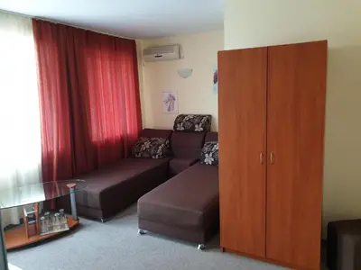 a living room with a couch and a cabinet at Family Hotel Diana in Pomorie