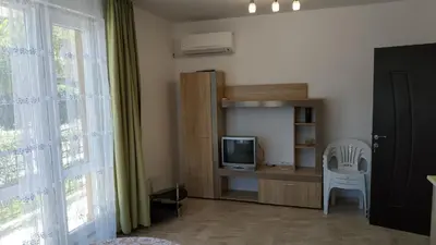 a room with a desk with a tv and a chair at Complex Argo in Ravda