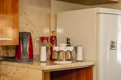 a kitchen with a counter with a refrigerator at Colorful 1-BDR Apartment - Top center of Burgas by Flаt Manаger in Burgas City