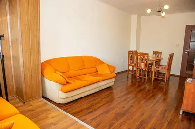an orange couch in a living room with a table at Colorful 1-BDR Apartment - Top center of Burgas by Flаt Manаger in Burgas City