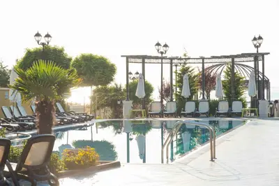 a swimming pool with lounge chairs and a swimming pool at Marina White Sands Beach Hotel-All Inclusive in Obzor