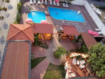 an overhead view of a swimming pool with tables and umbrellas at Alba Family Club Hotel in Primorsko