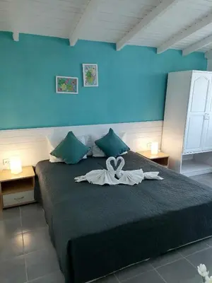 a bedroom with a bed with a swan on it at Alba Family Club Hotel in Primorsko