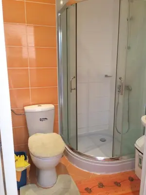 a bathroom with a toilet and a glass shower at Apartment on the sea at St Nikolas Complex-Ira in Chernomorets