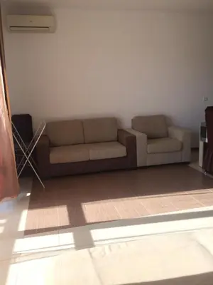 a living room with two brown couches in a room at Apartment on the sea at St Nikolas Complex-Ira in Chernomorets
