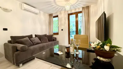a living room with a couch and a table at GARDEN OF EDEN Modern Apartments - APARTELLO,com in Sveti Vlas