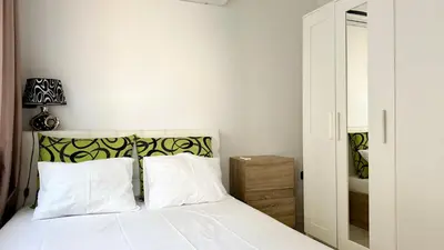 a bedroom with a white bed with white pillows at GARDEN OF EDEN Modern Apartments - APARTELLO,com in Sveti Vlas