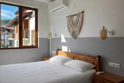 a bedroom with a white bed and a window at GARDEN OF EDEN Modern Apartments - APARTELLO,com in Sveti Vlas