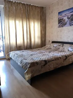 a bedroom with a bed and a window with curtains at Dunav Apt.1 in Ravda