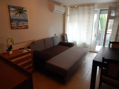 a living room with a couch and a table at Dunav Apt.1 in Ravda