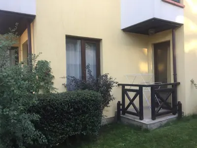 a table sitting outside of a house at Apartment on the sea at St Nikolas Complex-Irina in Chernomorets