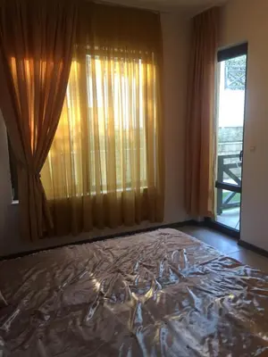 a bedroom with a large bed in front of a window at Apartment on the sea at St Nikolas Complex-Irina in Chernomorets