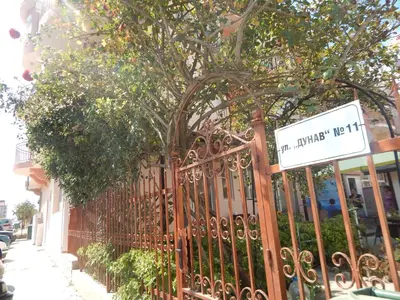 a wrought iron fence with a street sign on it at Dunav Apt.2 in Ravda