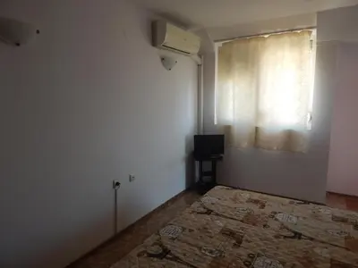 an empty room with a bed and a window at Dunav Apt.2 in Ravda