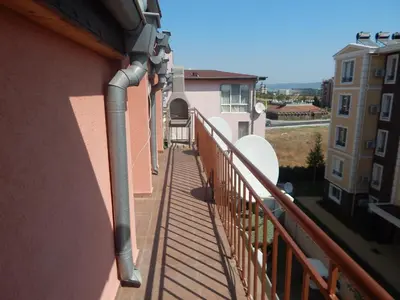 a balcony with a pipe on the side of a building at Dunav Apt.2 in Ravda