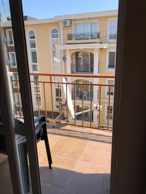 a balcony with a view of a building at Dunav Apt.2 in Ravda