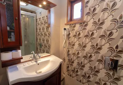 a bathroom with a sink and a shower curtain at Fener Guest House in Pomorie