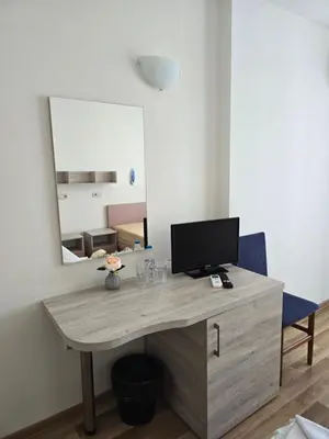 a desk with a computer on it with a mirror at Complex Astra in Sunny Beach