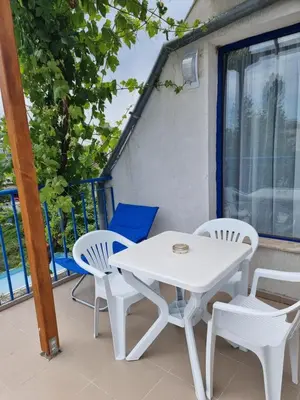 a white table and chairs on a balcony at Complex Astra in Sunny Beach