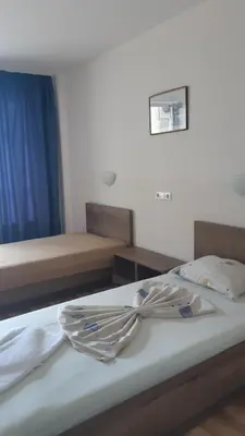 a bedroom with two beds with towels on the bed at Complex Astra in Sunny Beach