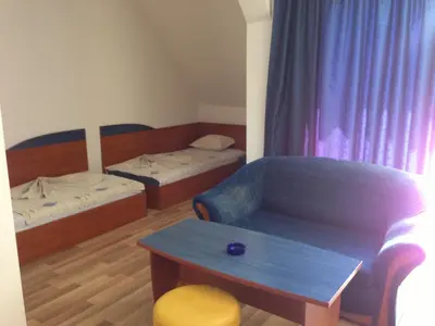 a room with two beds and a couch and a table at Complex Astra in Sunny Beach