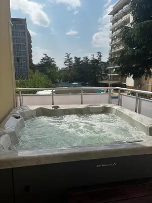 a hot tub on the balcony of a building at Hostel Malibu in Sunny Beach