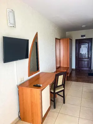 a desk with a television and a chair in a room at Hostel Malibu in Sunny Beach