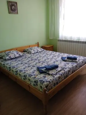 a bedroom with a bed with two objects on it at Къща за гости Ганчеви in Sozopol