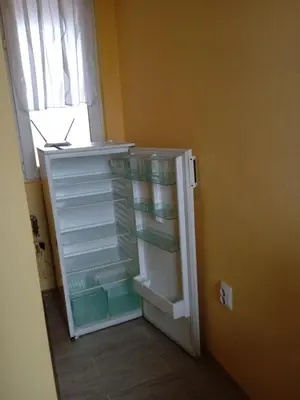 an empty refrigerator with its door open in a room at Къща за гости Ганчеви in Sozopol