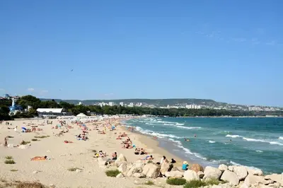 a group of people on a beach near the water at Unbeatable Location - New Lux Apartment Varna beach by Flat Mаnager in Varna City