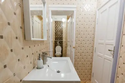 a bathroom with a sink and a toilet at Апартамент ELSOR in Burgas City