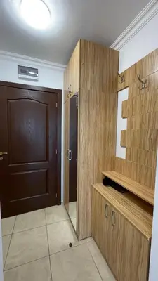 a bathroom with a wooden door and a room with a floor at FREGATA 15 Studio Sveti Vlas in Sveti Vlas