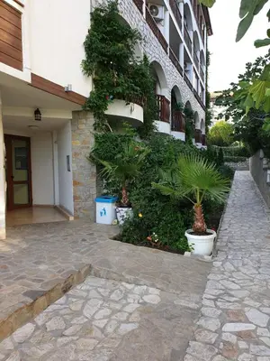 a building with potted plants on the side of it at FREGATA 15 Studio Sveti Vlas in Sveti Vlas
