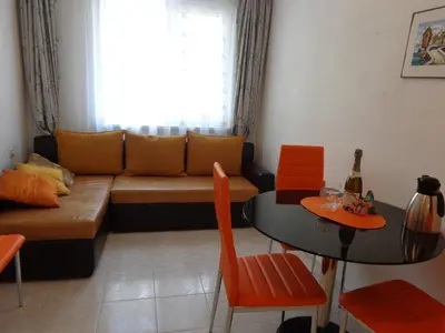 a living room with a couch and a table at Zoya Apartment in Burgas City
