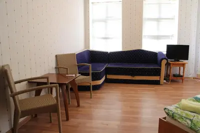 a living room with a couch and a table and chairs at Casablanca City in Varna City