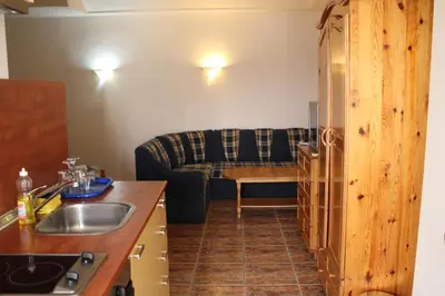 a kitchen with a couch and a living room at Casablanca City in Varna City