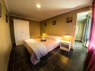 a bedroom with a bed and a table and two lamps at Alexander in Shkorpilovtsi
