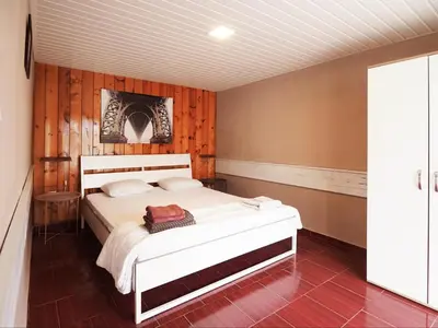 a bedroom with a white bed in a room at Alexander in Shkorpilovtsi
