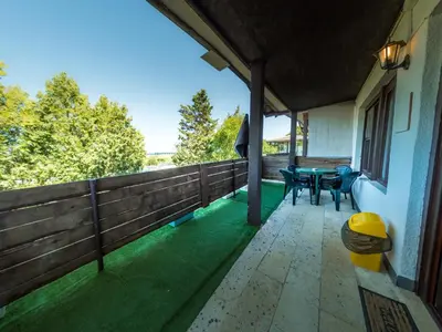 a porch with a table and chairs on it at Alexander in Shkorpilovtsi