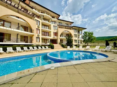 a hotel with a swimming pool in front of a building at Arkite Complex in Sunny Beach