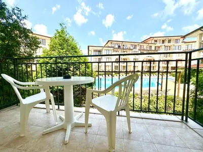 a balcony with a table and chairs and a view of a building at Arkite Complex in Sunny Beach