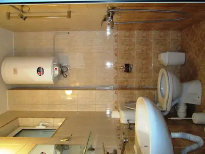 a bathroom with a shower and a toilet and a sink at Zoya Guest House in Ravda