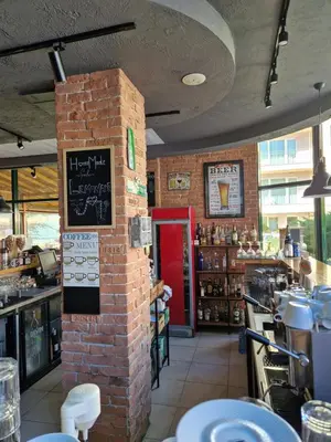 a restaurant with a brick pillar in the middle at Pool View Studio, Pollo Resort, Sunny Beach in Sunny Beach