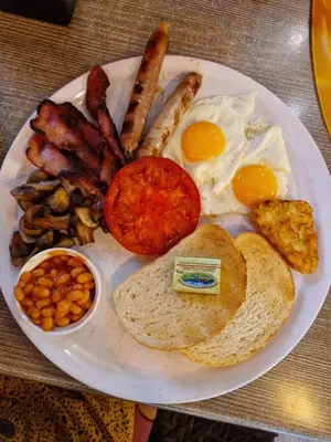 a plate of breakfast food with eggs bacon and beans at Pool View Studio, Pollo Resort, Sunny Beach in Sunny Beach