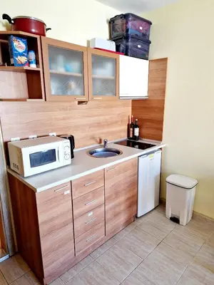 a small kitchen with a sink and a microwave at Pool View Studio, Pollo Resort, Sunny Beach in Sunny Beach